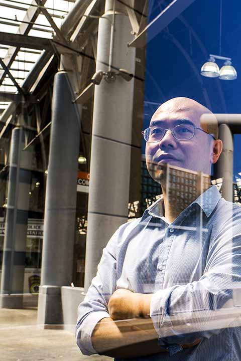 faculty member in front of structural architecture