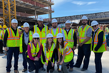 Jose velazquez with WS services team standing outside at a construction site