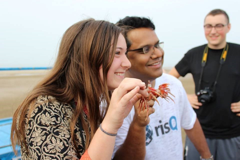 student with professor laughing and eating in India
