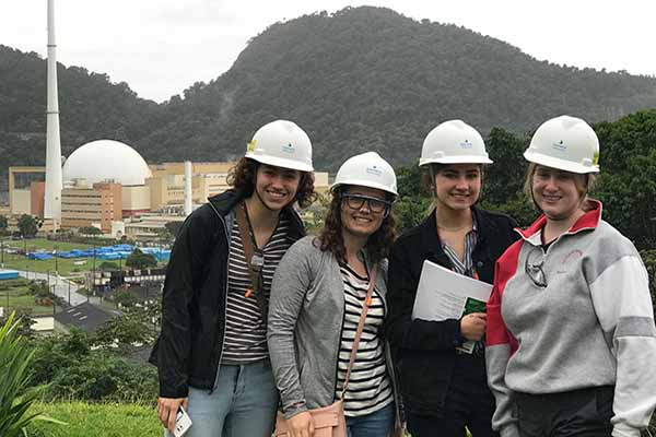 students in Brazil with hardhats at power plant